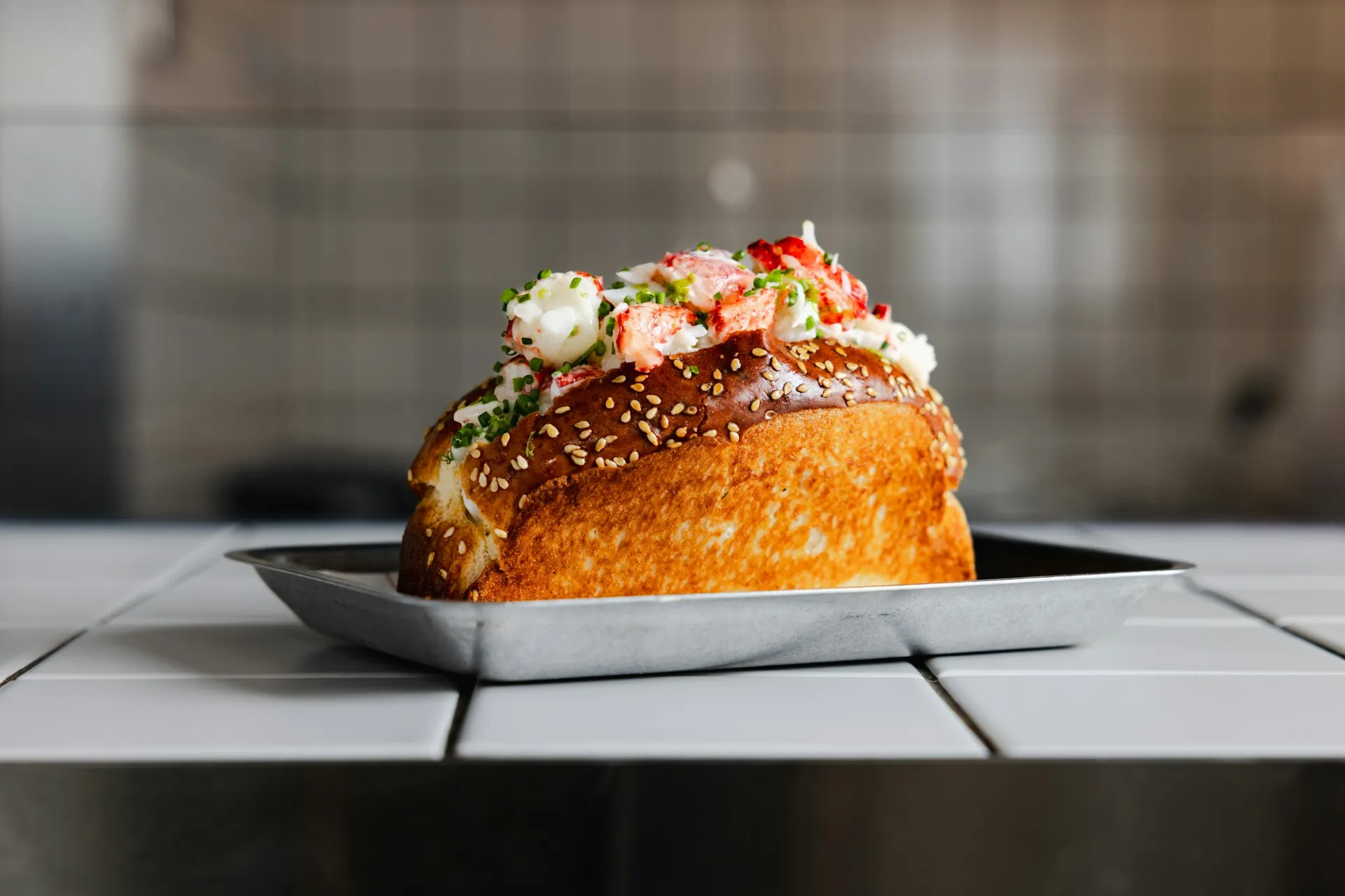 A lobster roll on a metal tray